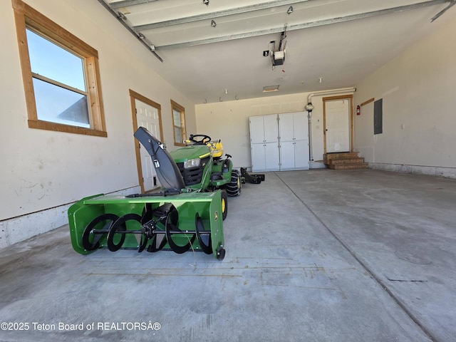 garage featuring electric panel and a garage door opener