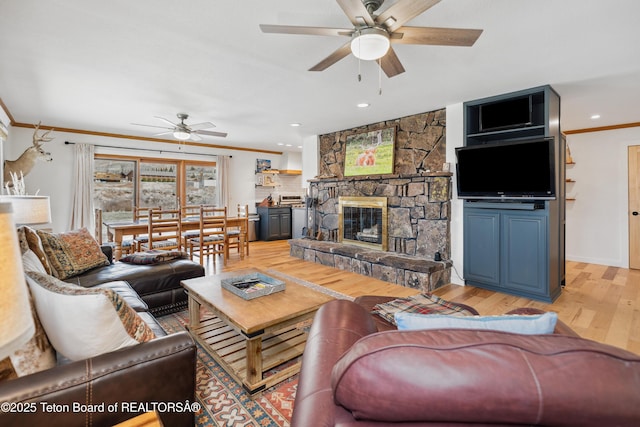 9 Warm Springs Rd, Dubois, WY 82513 - living area featuring crown molding, light wood-type flooring, a stone fireplace, ceiling fan, and recessed lighting