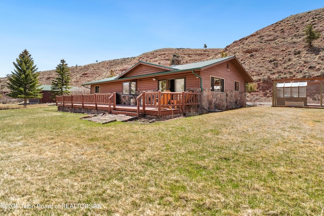 9 Warm Springs Rd, Dubois, WY 82513 - rear view of property with a yard, a deck with mountain view, and log veneer siding