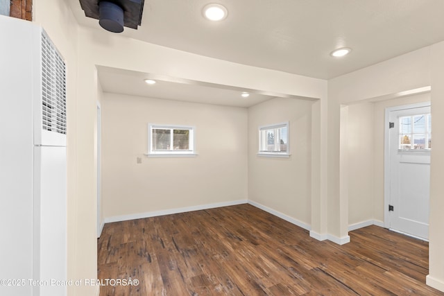 519 Jefferson, Afton, WY 83110 - below grade area featuring a heating unit, plenty of natural light, dark wood-style flooring, and recessed lighting