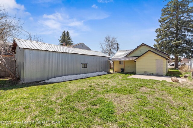 519 Jefferson, Afton, WY 83110 - view of property exterior featuring a lawn, metal roof, an outbuilding, and an outdoor structure