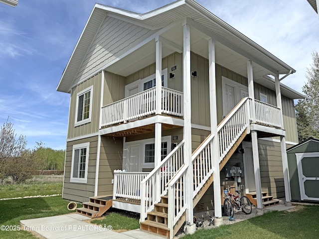 650 Centennial Mountain St, Driggs, ID 83422 - rear view of house with board and batten siding, stairs, a porch, and a yard