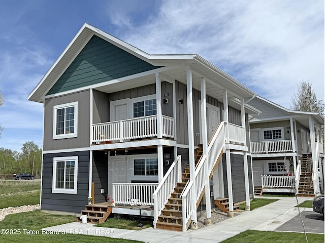 650 Centennial Mountain St, Driggs, ID 83422 - view of front of house with covered porch, board and batten siding, and stairway