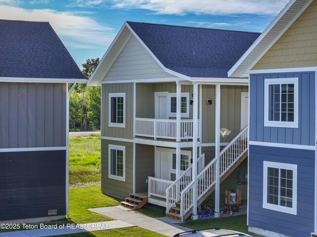 650 Centennial Mountain St, Driggs, ID 83422 - view of front of house with a shingled roof, board and batten siding, stairway, and a porch