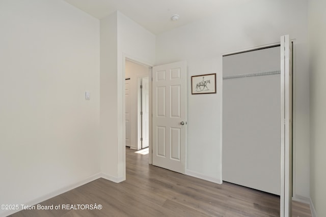 650 Centennial Mountain St, Driggs, ID 83422 - unfurnished bedroom with wood finished floors, a closet, and baseboards