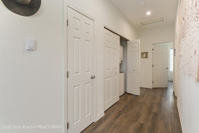 650 Centennial Mountain St, Driggs, ID 83422 - corridor with dark wood-type flooring, attic access, baseboards, stacked washing machine and dryer, and recessed lighting