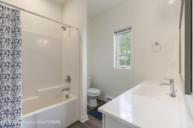 650 Centennial Mountain St, Driggs, ID 83422 - bathroom featuring baseboard heating, toilet, vanity, shower / bath combo with shower curtain, and wood finished floors
