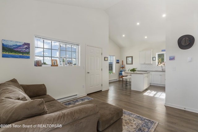650 Centennial Mountain St, Driggs, ID 83422 - living area with high vaulted ceiling, baseboard heating, dark wood-style floors, recessed lighting, and baseboards