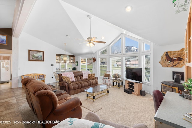 living area with ceiling fan, high vaulted ceiling, a wood stove, and recessed lighting