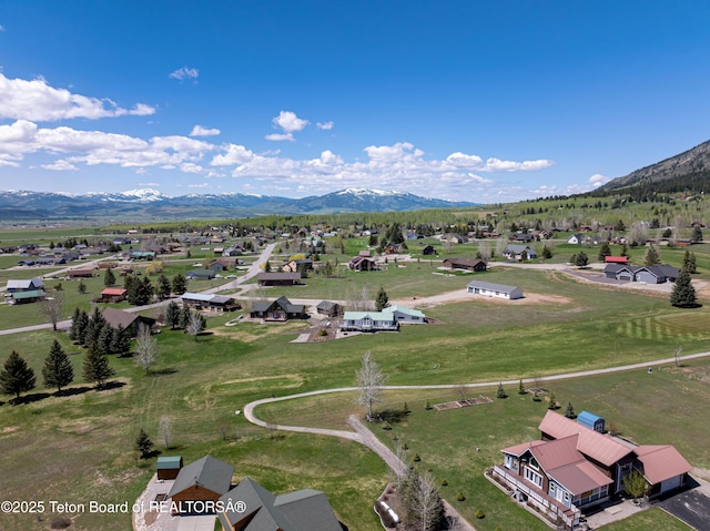 aerial view of residential area featuring mountains