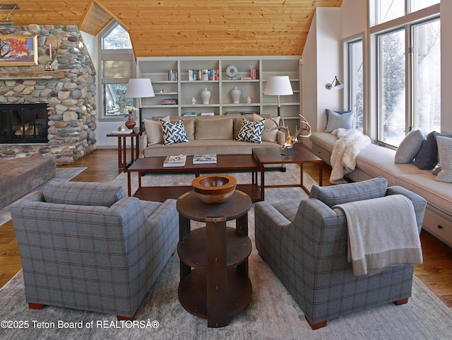 2985 N Alder Wood Ln, Wilson, WY 83014 - living room with wooden ceiling, vaulted ceiling, wood finished floors, and a fireplace
