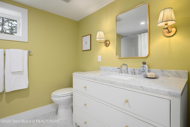 735 Snow King Dr, Jackson, WY 83001 - bathroom with vanity, toilet, and baseboards