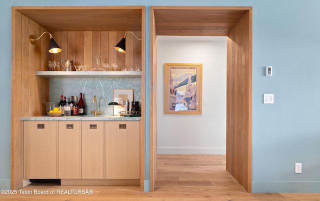 735 Snow King Dr, Jackson, WY 83001 - indoor dry bar with light wood-type flooring, tasteful backsplash, and baseboards