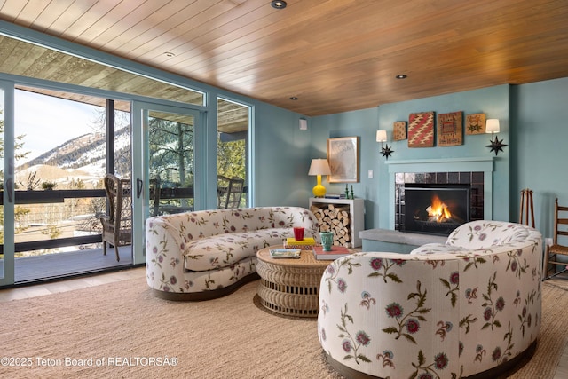 735 Snow King Dr, Jackson, WY 83001 - living room with a mountain view, wooden ceiling, a tile fireplace, floor to ceiling windows, and recessed lighting