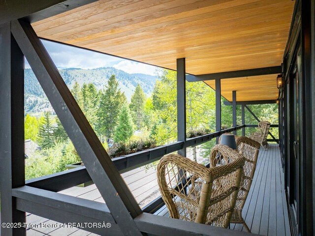 735 Snow King Dr, Jackson, WY 83001 - sunroom / solarium with a mountain view, plenty of natural light, and a wooded view
