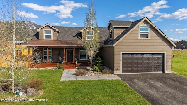 350 Little Greys Loop, Etna, WY 83118 - view of front of property featuring a porch, asphalt driveway, an attached garage, and a front yard