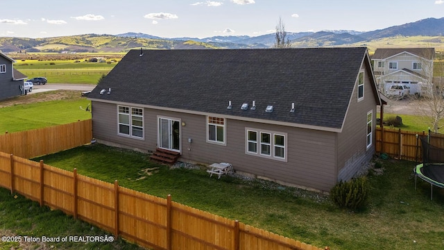 350 Little Greys Loop, Etna, WY 83118 - back of house featuring a trampoline, entry steps, a mountain view, and roof with shingles