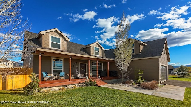350 Little Greys Loop, Etna, WY 83118 - cape cod home featuring a porch, a garage, and driveway