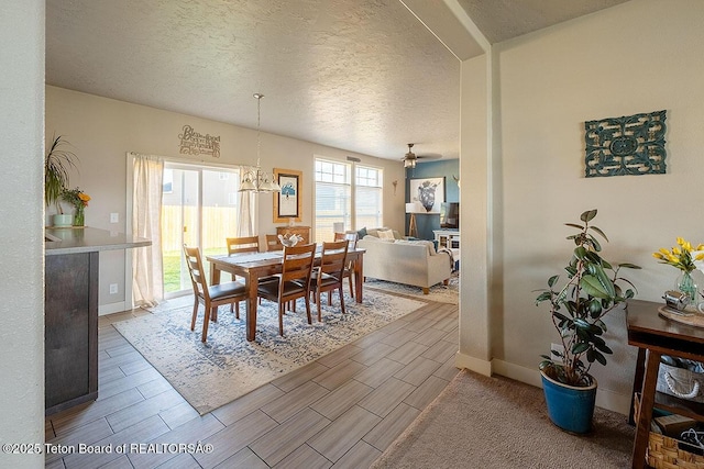 350 Little Greys Loop, Etna, WY 83118 - dining area featuring wood tiled floors, a textured ceiling, and baseboards