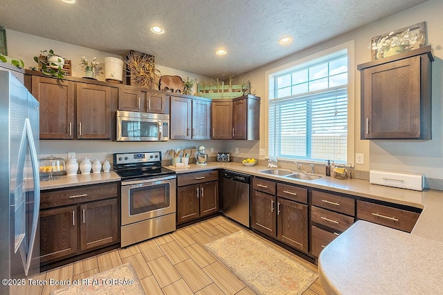 350 Little Greys Loop, Etna, WY 83118 - kitchen with stainless steel appliances, a sink, recessed lighting, light countertops, and a textured ceiling