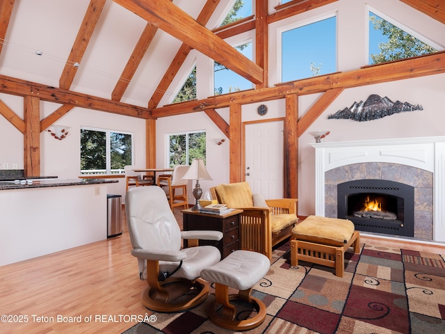3750 Grandview Dr, Tetonia, ID 83452 - living room with high vaulted ceiling, a fireplace, beam ceiling, and light wood finished floors