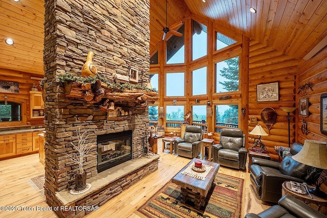 109 Redwood Rd, Star Valley Ranch, WY 83127 - living room featuring high vaulted ceiling, wood ceiling, rustic walls, a fireplace, and light wood-style flooring