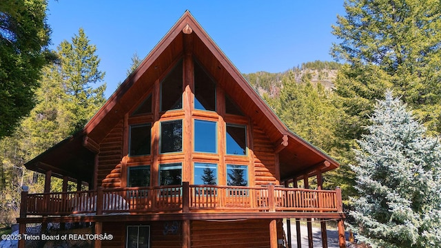 109 Redwood Rd, Star Valley Ranch, WY 83127 - back of property featuring a wooden deck and a forest view