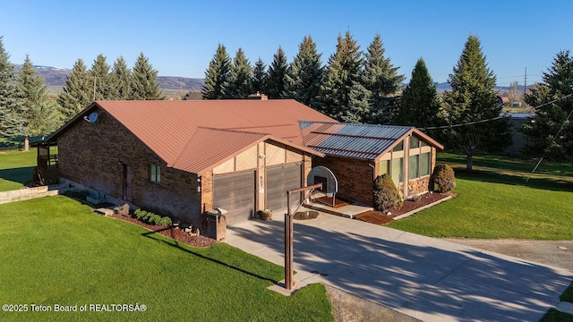 823 Allred Rd, Afton, WY 83110 - view of front facade featuring stone siding, a garage, concrete driveway, a front yard, and metal roof