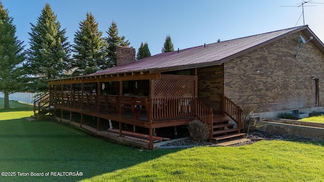 823 Allred Rd, Afton, WY 83110 - rear view of house with a chimney, a yard, a deck, metal roof, and brick siding
