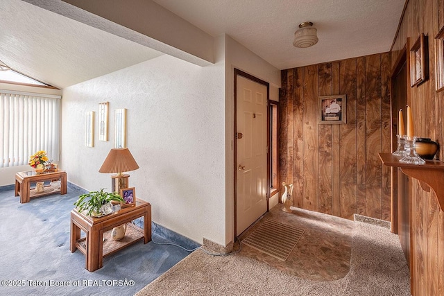 823 Allred Rd, Afton, WY 83110 - corridor featuring wood walls, a textured ceiling, carpet floors, and a textured wall