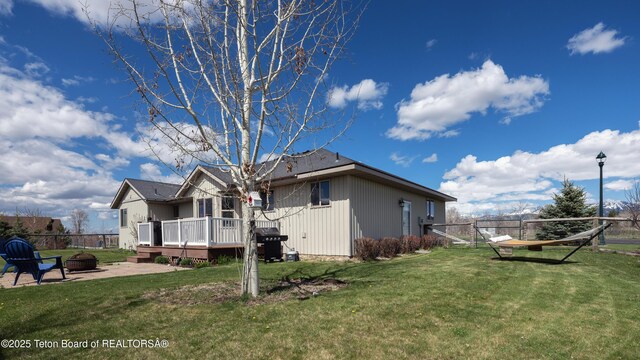 700 Guardian Peaks Ln, Driggs, ID 83422 - view of property exterior with an outdoor fire pit and a wooden deck