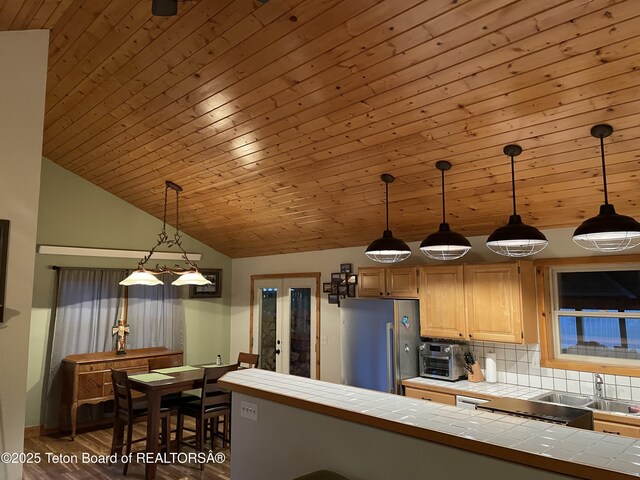 51 Cheyenne Cir, Star Valley Ranch, WY 83127 - kitchen with freestanding refrigerator, tile counters, a sink, wood finished floors, and tasteful backsplash
