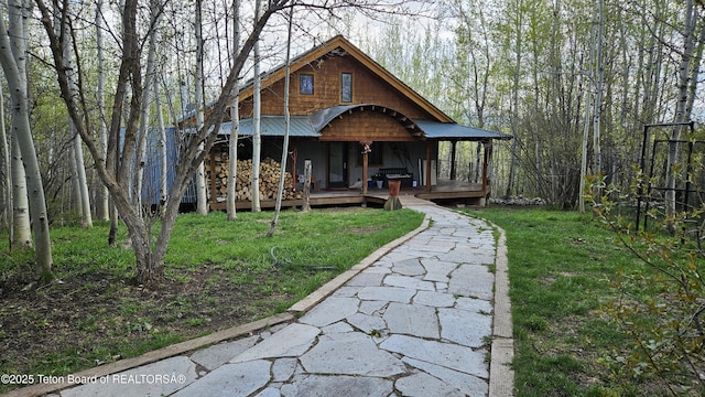 2435 Steelhead Dr, Tetonia, ID 83452 - view of front facade with a porch, a front lawn, and metal roof