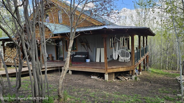 2435 Steelhead Dr, Tetonia, ID 83452 - view of home's exterior with metal roof, a deck, and a view of trees