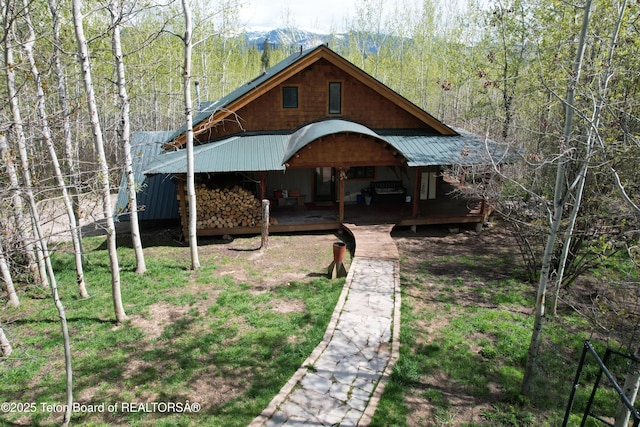 2435 Steelhead Dr, Tetonia, ID 83452 - view of front of property featuring covered porch, metal roof, and a view of trees