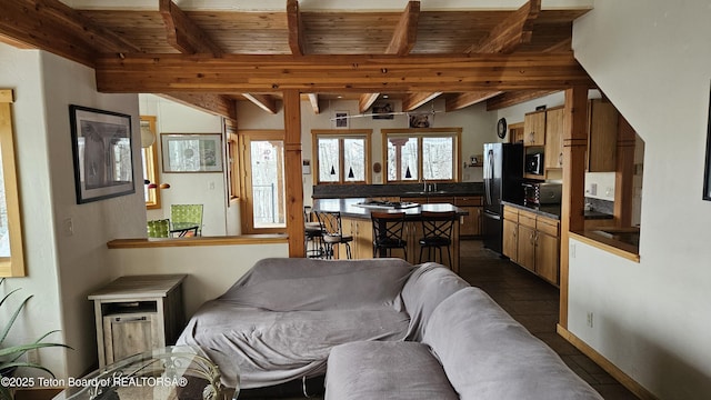 2435 Steelhead Dr, Tetonia, ID 83452 - living room featuring beam ceiling, wood ceiling, and dark tile patterned flooring