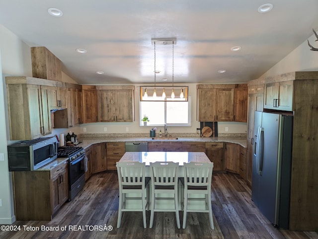 543 Rockbridge Dr, Afton, WY 83110 - kitchen with appliances with stainless steel finishes, a sink, vaulted ceiling, dark wood-style floors, and brown cabinets