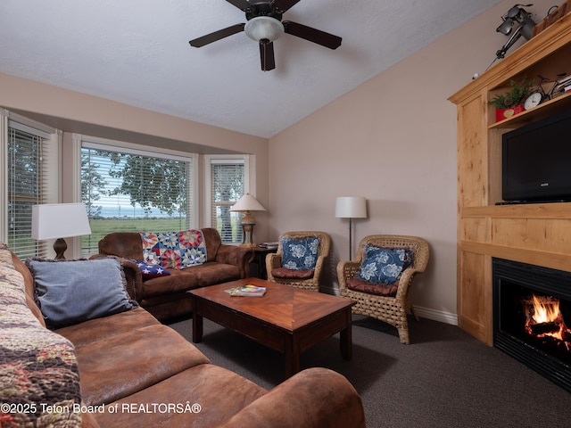 525 Booshway St, Driggs, ID 83422 - carpeted living area featuring vaulted ceiling, ceiling fan, and a lit fireplace