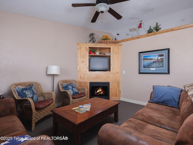 525 Booshway St, Driggs, ID 83422 - living area with carpet, a ceiling fan, baseboards, and a warm lit fireplace
