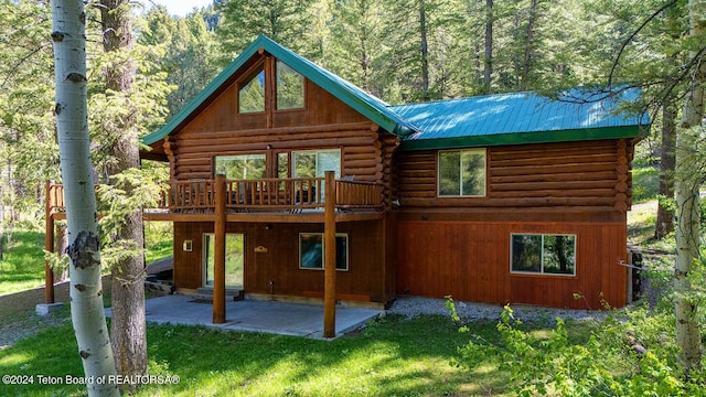 1238 Vista Dr, Star Valley Ranch, WY 83127 - rear view of property featuring log siding, a patio area, a lawn, and a wooden deck