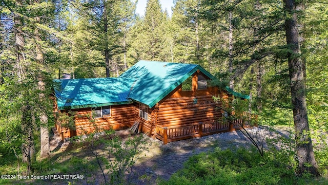1238 Vista Dr, Star Valley Ranch, WY 83127 - view of property exterior featuring log exterior, a wooded view, and metal roof