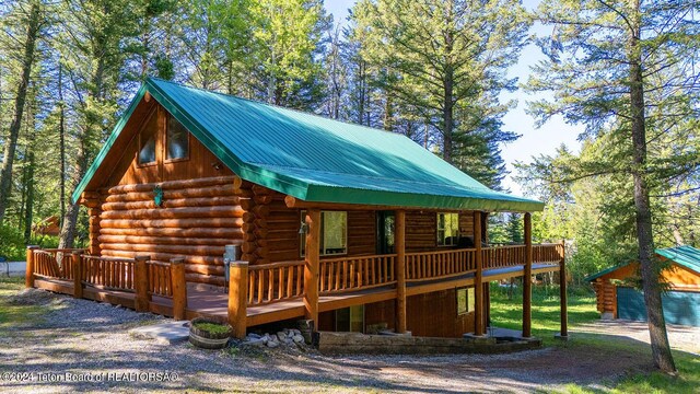 1238 Vista Dr, Star Valley Ranch, WY 83127 - view of front of home with log siding, a deck, and an outdoor structure