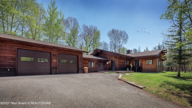 529 Quaking Aspen Dr, Driggs, ID 83422 - view of front of property featuring asphalt driveway, a front yard, a chimney, and an attached garage