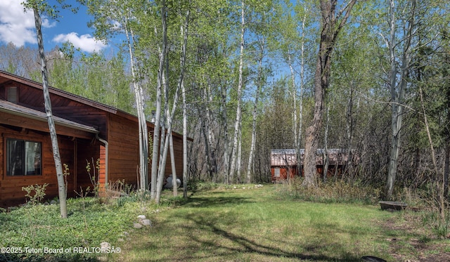 529 Quaking Aspen Dr, Driggs, ID 83422 - view of green lawn featuring a wooded view