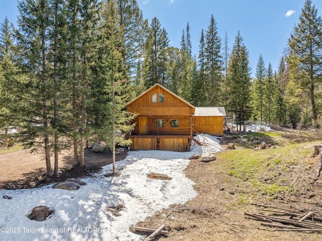 2 Porcupine Cir, Dubois, WY 82513 - view of home's exterior with a metal roof and a wooded view