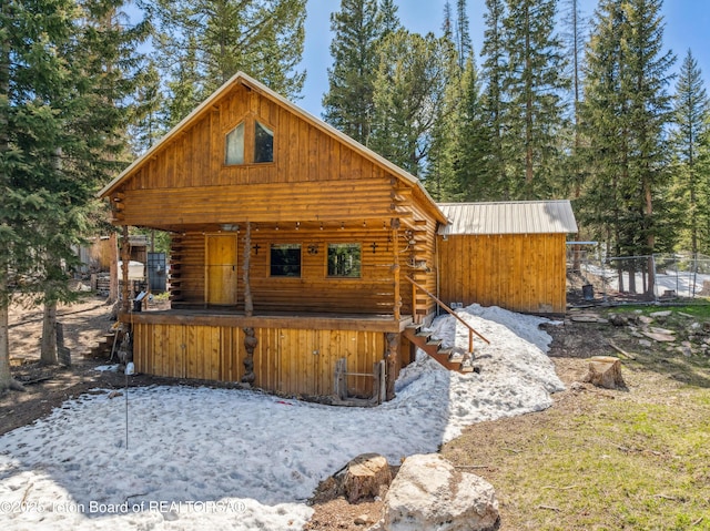 2 Porcupine Cir, Dubois, WY 82513 - view of front of house featuring log siding and an outbuilding