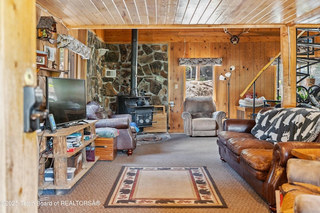 2 Porcupine Cir, Dubois, WY 82513 - carpeted living room with a wood stove, wooden ceiling, and wooden walls