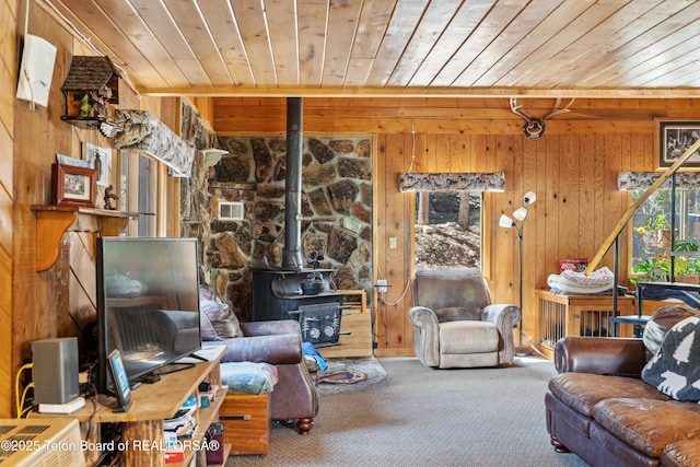 2 Porcupine Cir, Dubois, WY 82513 - carpeted living room featuring wooden ceiling, a wood stove, and wooden walls