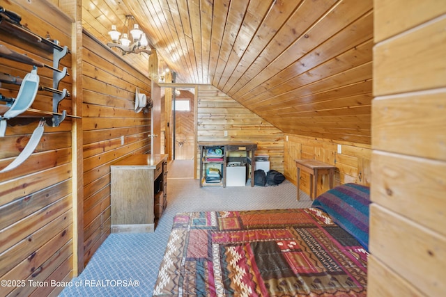 2 Porcupine Cir, Dubois, WY 82513 - unfurnished bedroom with wood walls, carpet flooring, lofted ceiling, wooden ceiling, and a chandelier