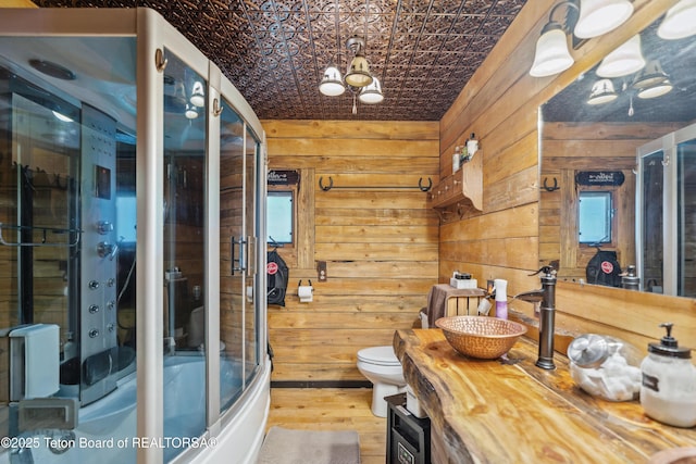 2 Porcupine Cir, Dubois, WY 82513 - bathroom with vanity, wood walls, wood finished floors, an ornate ceiling, and healthy amount of natural light